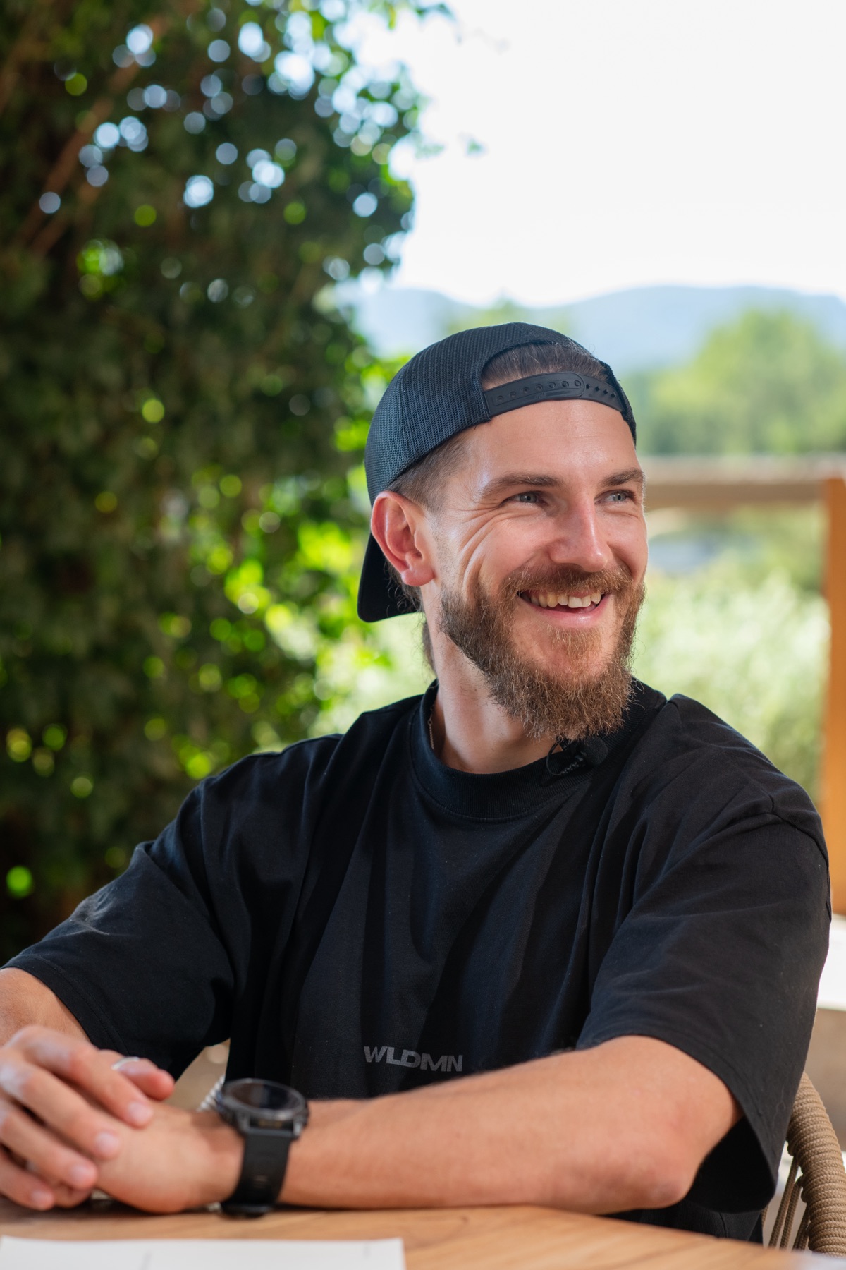Callum Hardingham smiling in a black WLDMN t-shirt
